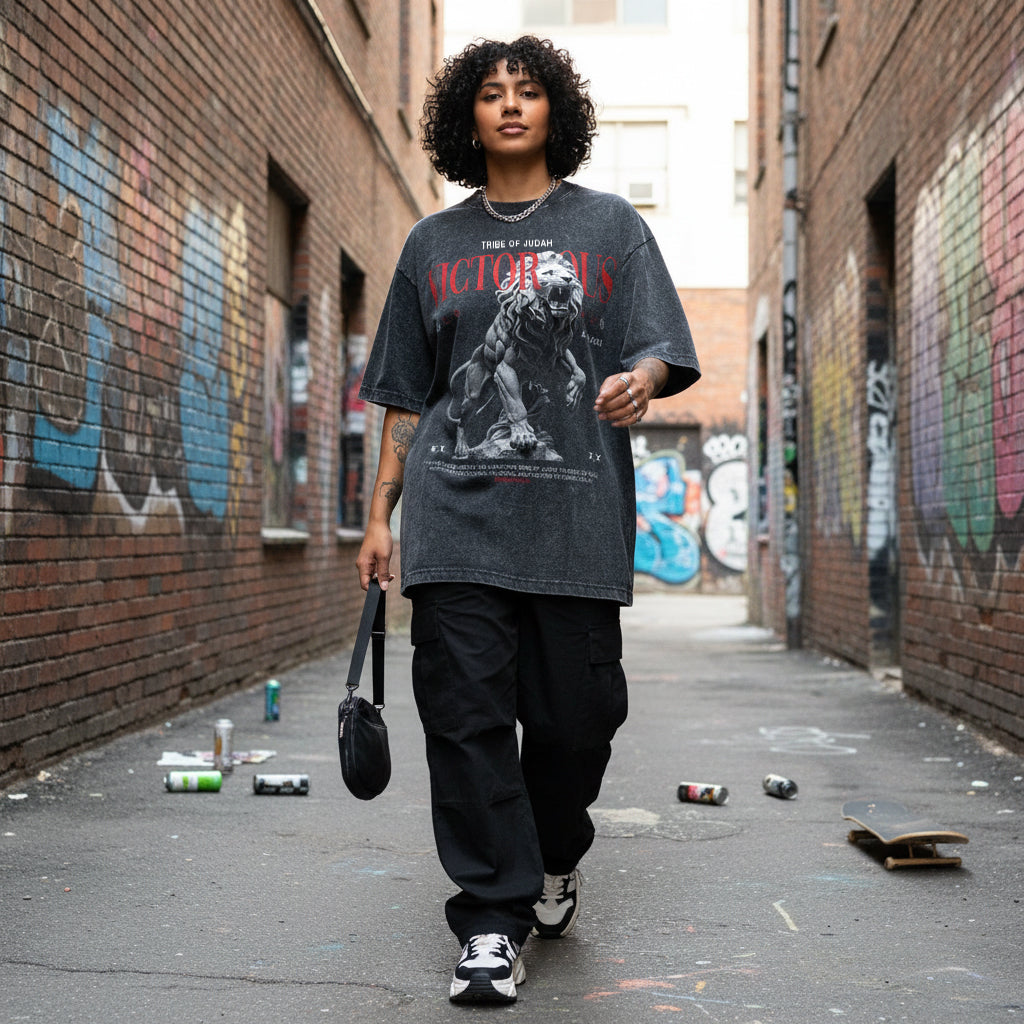 Woman wearing a graphic t-shirt walking down a graffiti-covered alley.